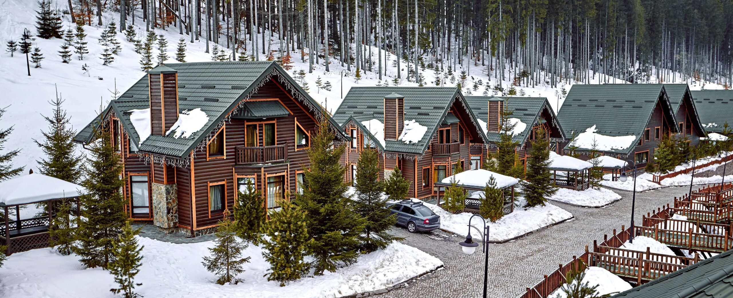 winter-vacation-holiday-wooden-house-mountains-covered-with-snow-blue-sky-skis-front-house (1) (2)