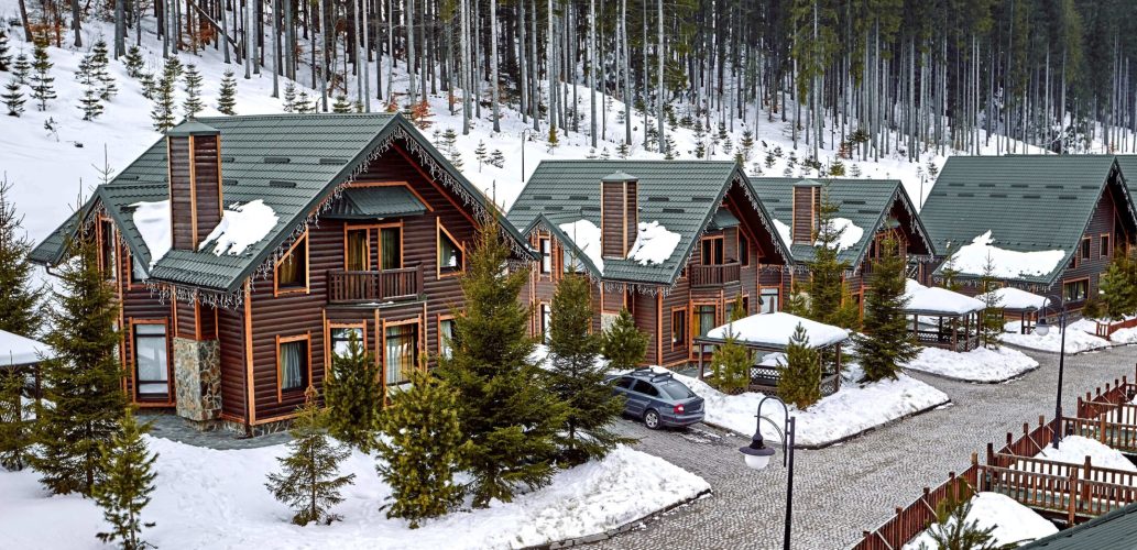 winter-vacation-holiday-wooden-house-mountains-covered-with-snow-blue-sky-skis-front-house (1) (2)